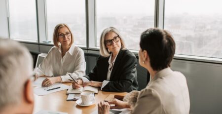 People in a board room meeting discussing business succession planning